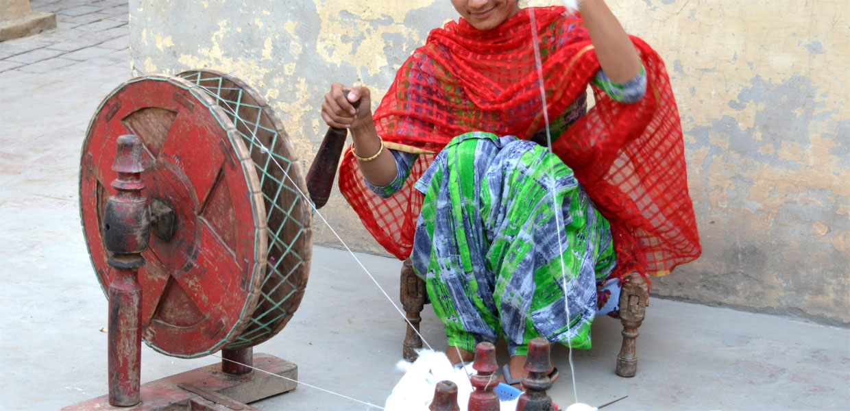 Lady Artisan Spinning Cotton Yarn by Hand on Charkha